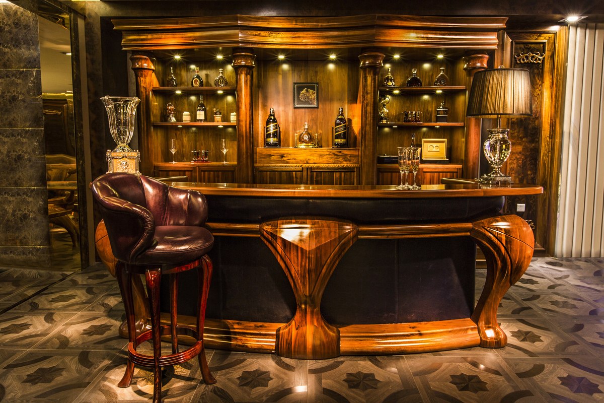Sculpted timber bar counter with dark inset panels