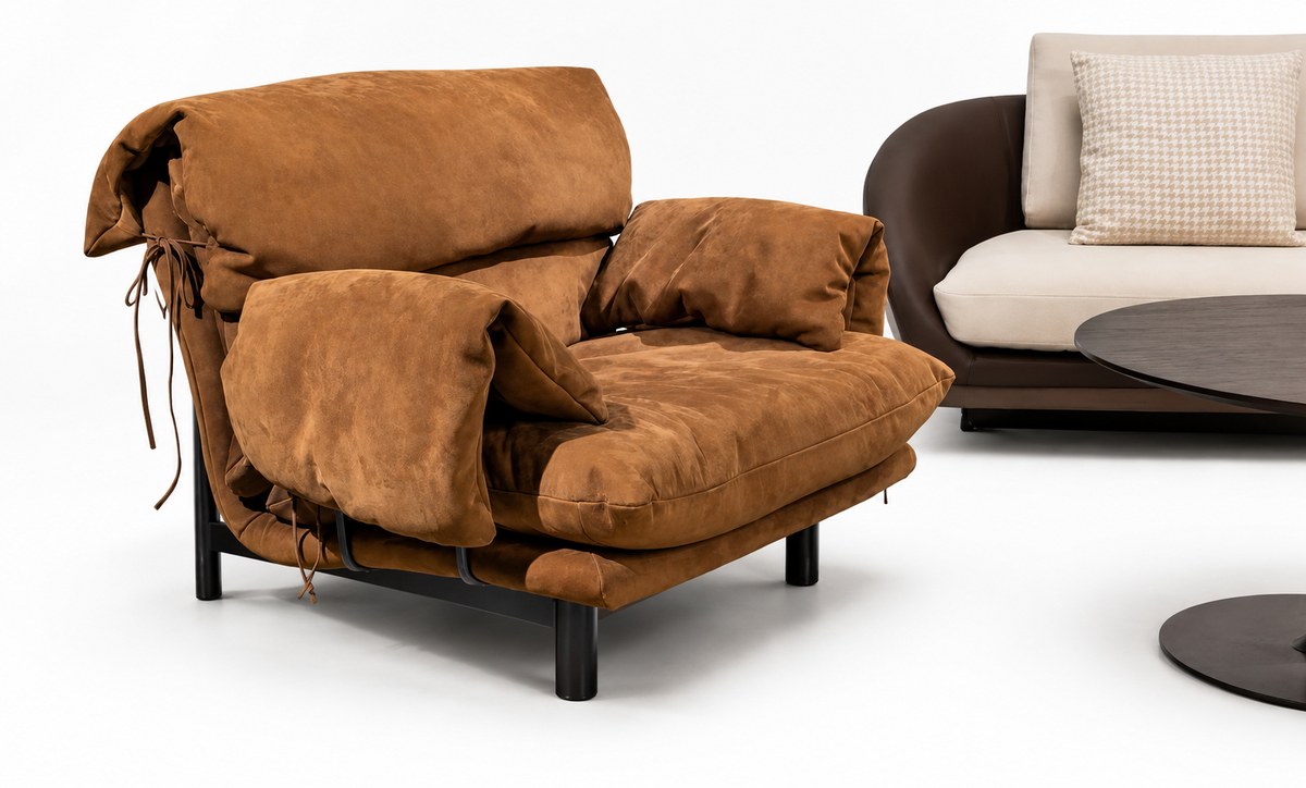 Cognac lounge chair; part of a second chair at right