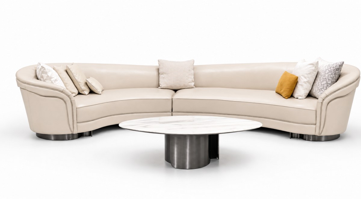 Curved ivory sectional; oval occasional table